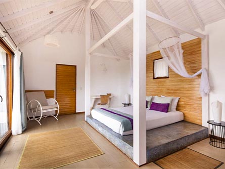 A spacious room with a bed on a platform at the Hotel Altiplanico on Easter Island.