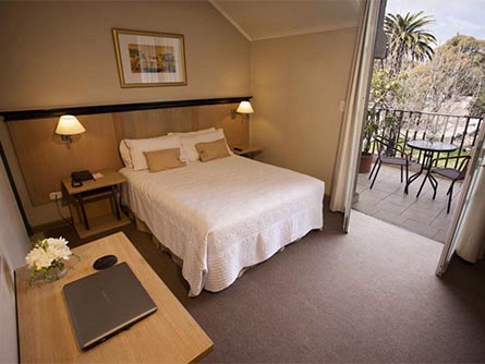 A cozy and tastefully-decorated room at the Hotel Carlos V Patagonia in Bariloche.