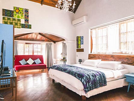 A creatively-decorated room with high ceilings at the Iguanazu Bed & Breakfast in Guayaquil.