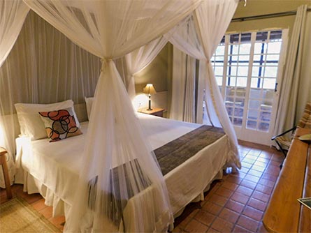 A cozy room with tile floors and wooden furniture at the Mutum Lodge in the Pantanal.