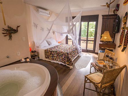 A hotel room at the Pousada Natur Campeche in Florianopolis with various decorations on the walls.