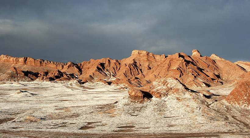 The Atacama Salt Flats surrounded by rugged terrain and interesting rock formations.