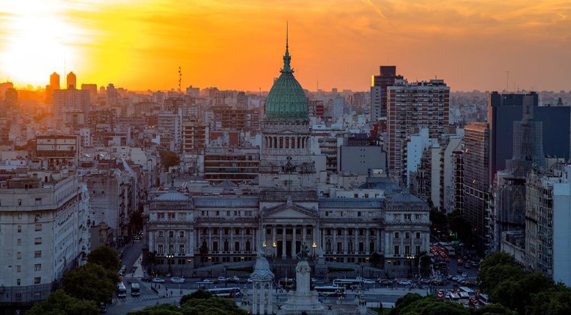 Sun setting over the Palace of the Argentine National Congress and the Buenos Aires skyline.