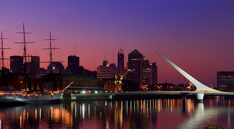 Night falling over the Puente de la Mujer bridge in the Puerto Madero district of Buenos Aires.