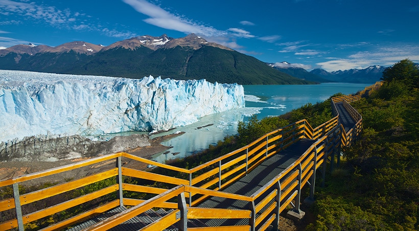 A pathway leading past the blue-tinted Perito Moreno glacier in Los Glaciares National Park.