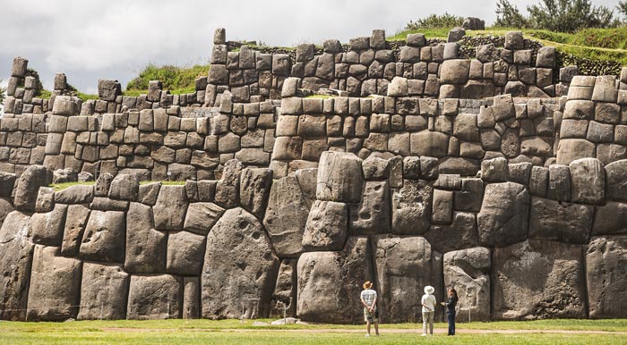 Visitors admiring some enormous stone walls at the Inca fortress of Sacsayhuamán.