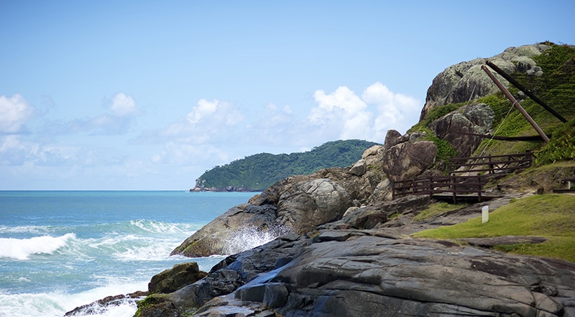 Waves splashing up on some rocks at a park in the Brazilian city of Florianópolis.