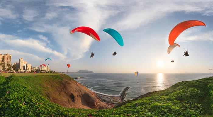 Paragliders soaring through the sky over the Costa Verde in Lima’s Miraflores District.