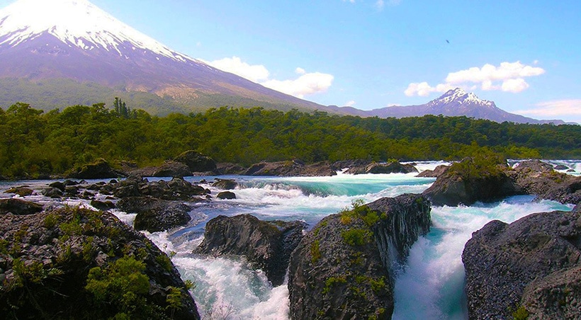 Petrohue Falls overlooked by the majestic Osorno Volcano in Vicente Pérez Rosales National Park.