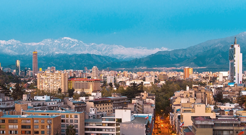 View of the city of Santiago, with the snow-capped Andes Mountains towering overhead.