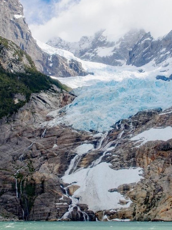 Close up view of the Balmaceda Glacier, a hanging glacier located between two mountain peaks.