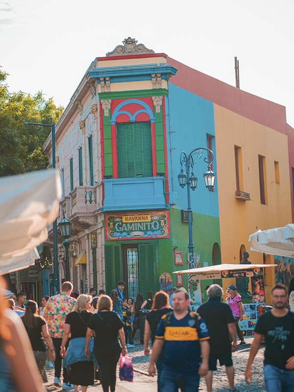 Visitors walking down the cobblestone streets of the Caminito district in Buenos Aires.