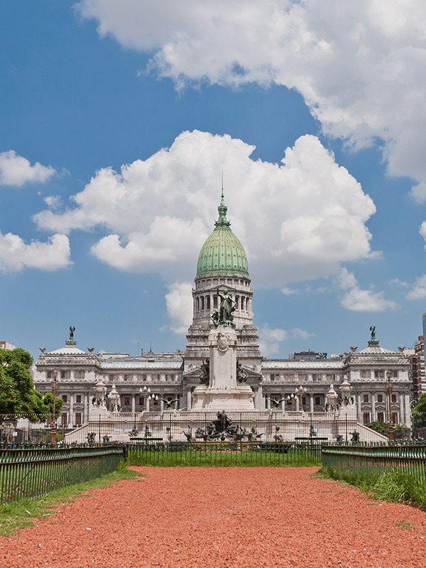 The Palace of the Argentine National Congress overlooking a statue and small park.