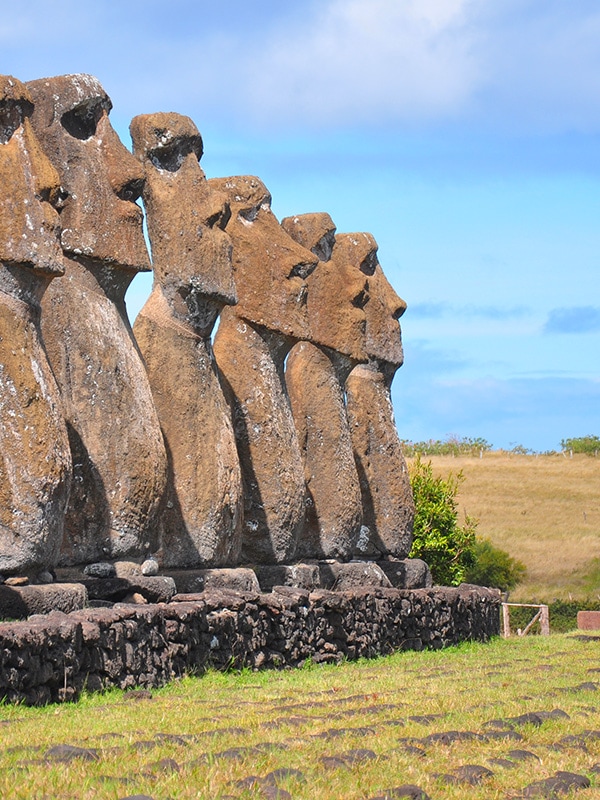 A row of moais, the human figures made of stone left by the inhabitants of Easter Island.