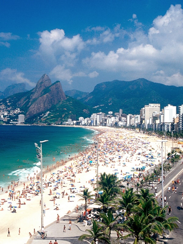 A sunny day with lots of people at one of Rio de Janeiro's world-famous beaches.