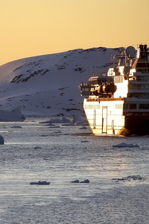 A cruise ship navigating through the icy waters off the coast of Antarctica.