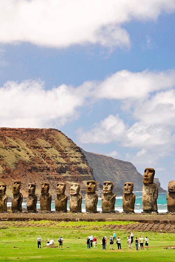 Visitors admiring a line of moais, the monolithic human figures found on Easter Island.