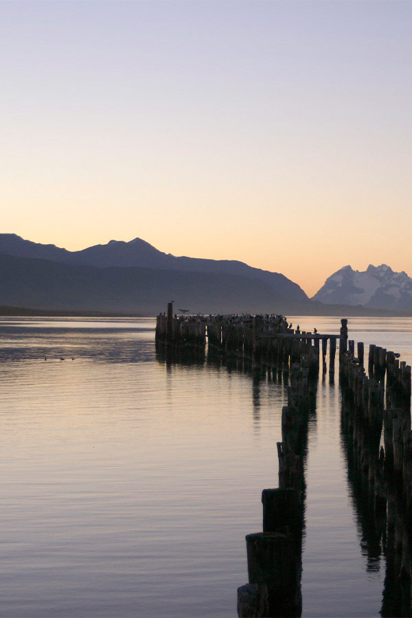 A wooden pier extending into the Almirante Montt Gulf near Puerto Natales in Chilean Patagonia.