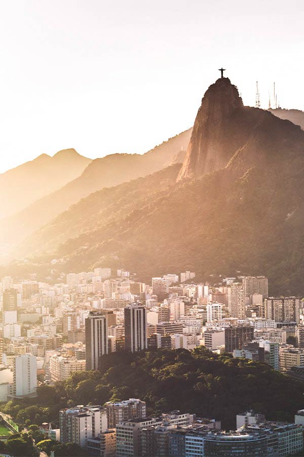 The city of Rio de Janeiro and the iconic Sugarloaf Mountain illuminated at night.