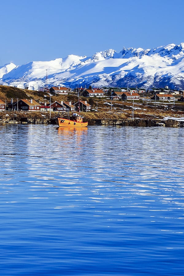Boats in the Beagle Channel near Ushuaia with snow-capped Andean Mountains overhead.