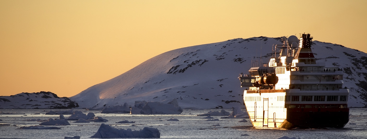 A cruise ship navigating through the icy waters off the coast of Antarctica.