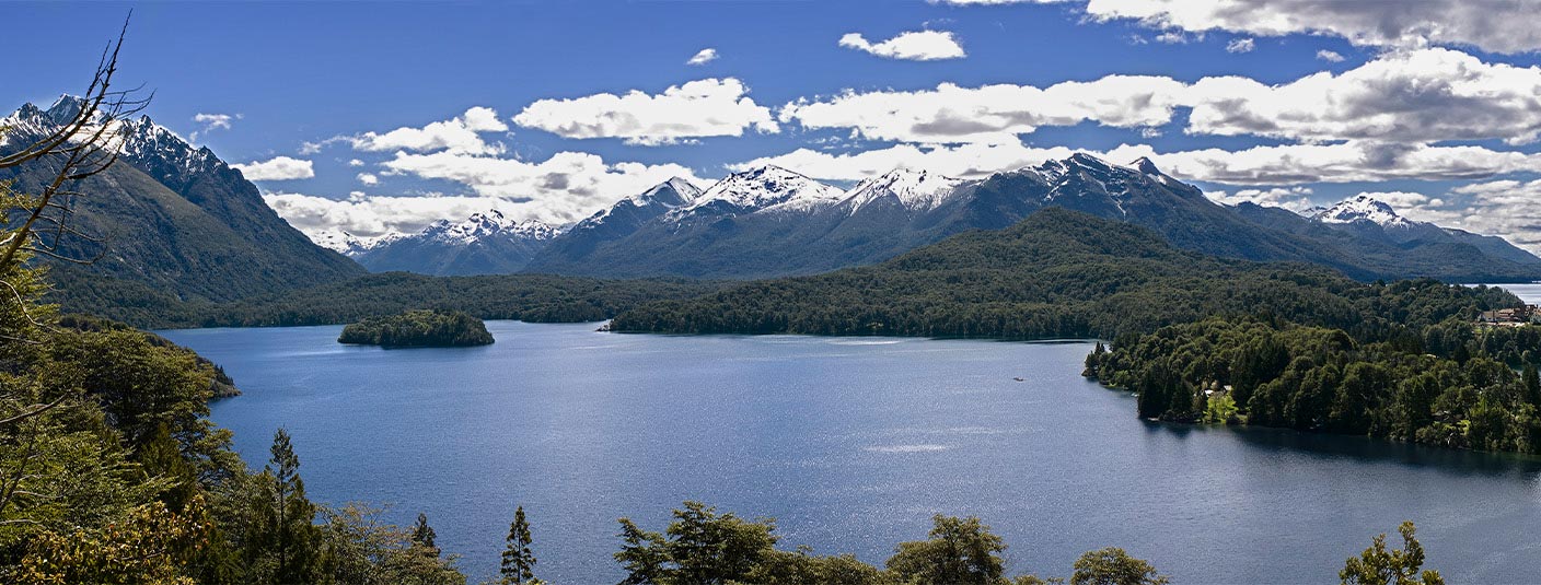 The gorgeous Lake Nahuel Huapi, surrounded by snow-capped mountains and alpine forest.