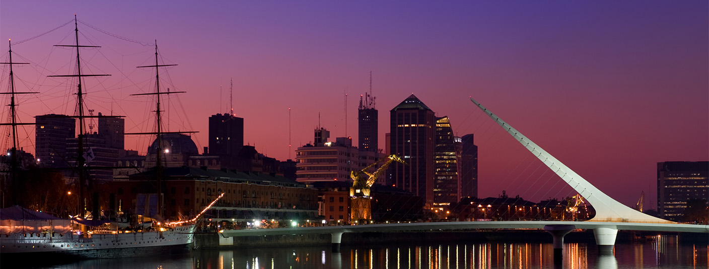 Night falling over the Puente de la Mujer bridge in the Puerto Madero district of Buenos Aires.