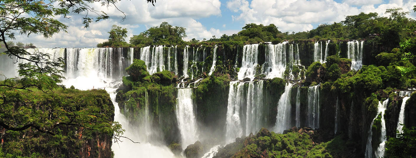 Lush green vegetation and waterfalls at Iguazu Falls, the largest waterfall in the world.