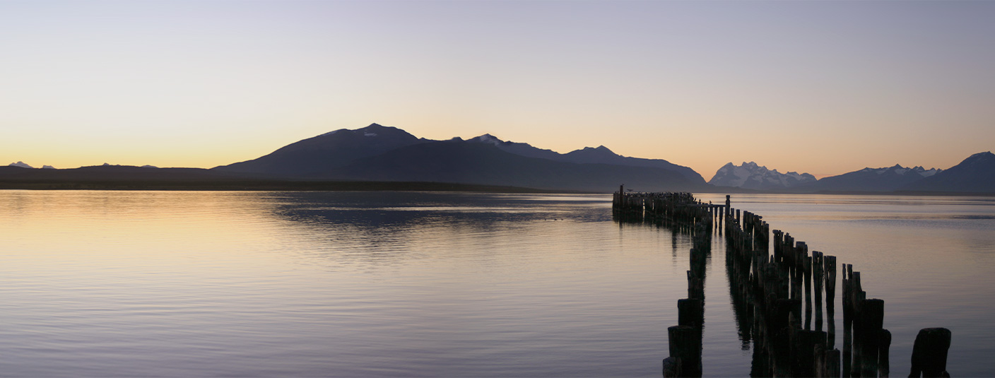 A wooden pier extending into the Almirante Montt Gulf near Puerto Natales in Chilean Patagonia.