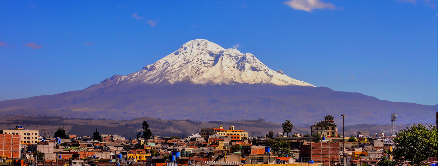 The iconic snow-capped Volcano Chimborazo overlooking the city of Riobamba in Ecuador.