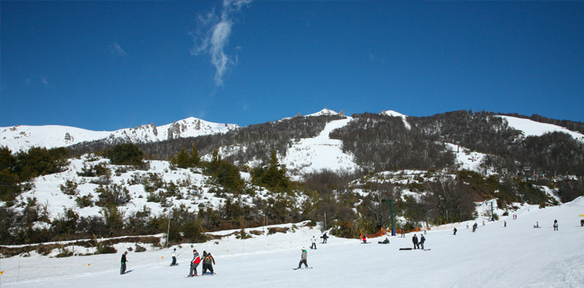 A snowy mountain landscape with blue skies at the Cerro Catedral in Argentina