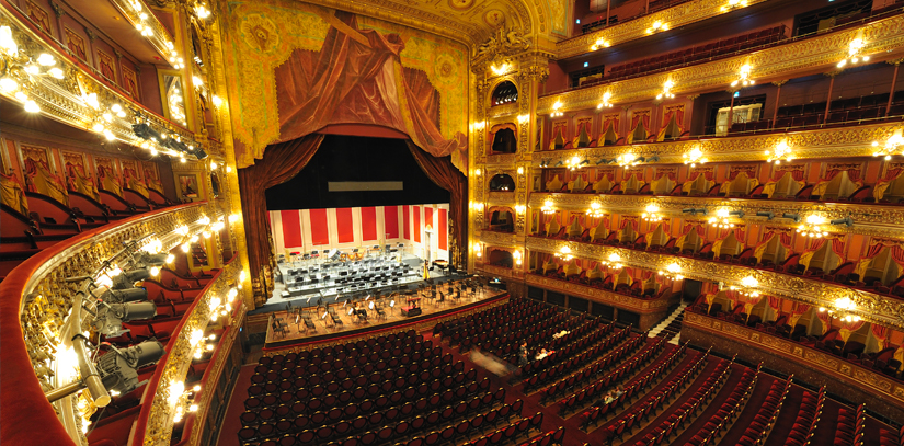 The elaborate Teatro Colon of Buenos Aires with empty seats, stage and soaring dome ceiling
