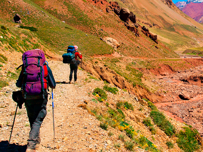 Two hikers hiking up a hill in Argentina