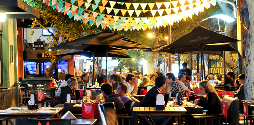 A group of people sitting at tables in a bar in Mendoza, Argentina enjoying the nightlife