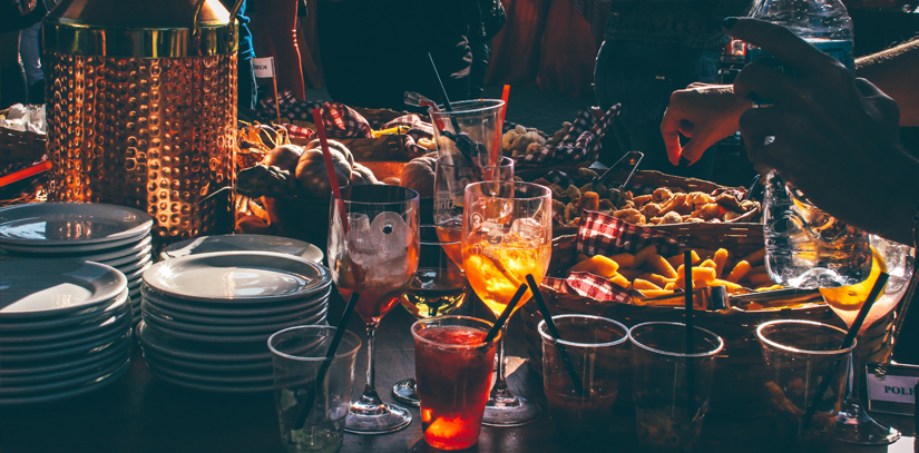 An array of food plates and cocktails at a popular bar in São Paolo