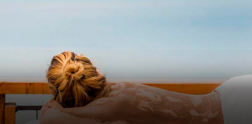 A woman enjoying a massage overlooking the ocean at the Los Cauquenes Hotel