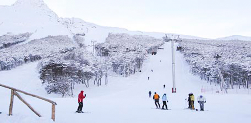 People skiing on the Cerro Castor snowy mountain
