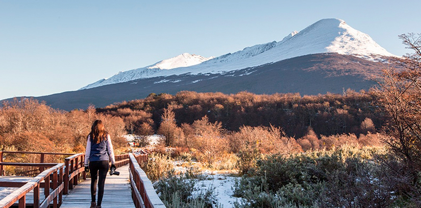 A woman walking towards the impressive Tierra del Fuego mountain