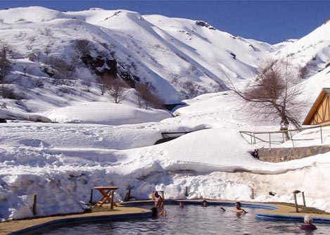Visitors relaxing in some thermal baths surrounded by snow in the resort city of Chillán.