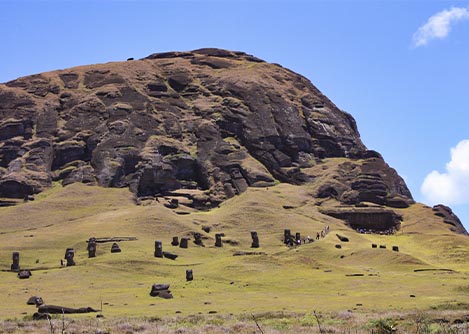 Several of the monolithic sculptures known as moais surrounding the volcanic crater of Rano Raraku.