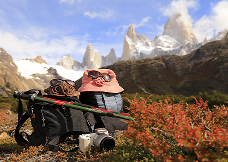 Hiking gear and a camera set down in the brush along the hiking trail to Mount Fitz Roy.