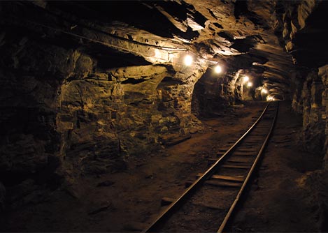 Railroad tracks leading through an underground tunnel at the Passagem Mines in Ouro Preto.