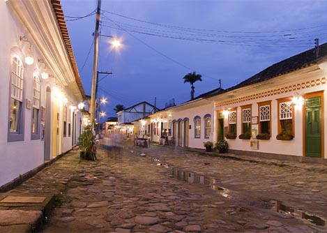 A cobblestone street lined with classic houses in the Historic Center of Paraty.