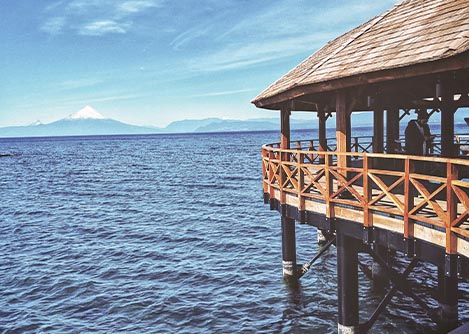 A covered dock on Lake Llanquihue with a view of the Osorno Volano in the distance.