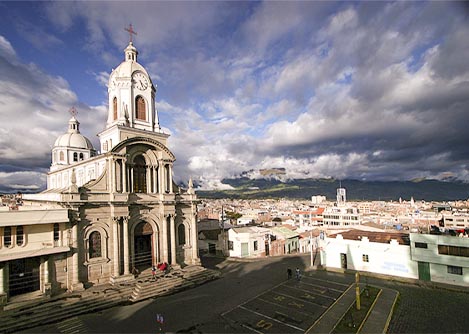 One of the many cathedrals in Riobamba, with the rooftops of the city visible in the background.