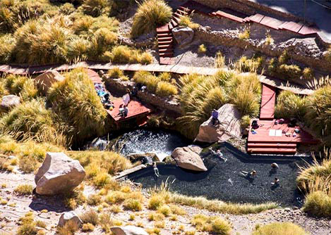 An aerial view of visitors relaxing at the Puritama Hot Springs in the Atacama Desert.