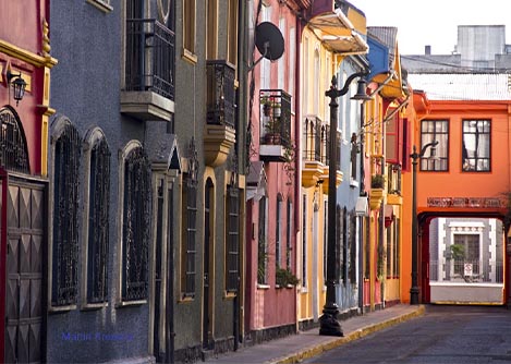 Colorful rowhouses on a street in the bohemian Bellavista neighborhood of Santiago.