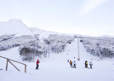 Visitors skiing on a snow-covered hill at the Cerro Castor ski resort near Ushuaia.