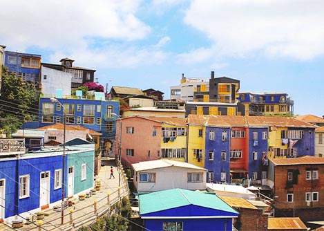 Colorful painted houses lining a hilltop in the coastal Chilean city of Valparaiso.